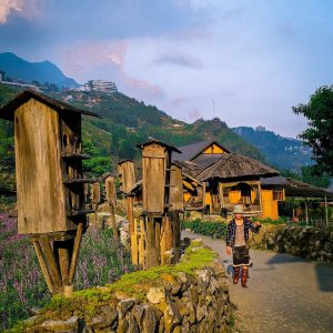 sapa-cat-cat-village-hmong-woman-strolling-stilt-houses-viettrendtour