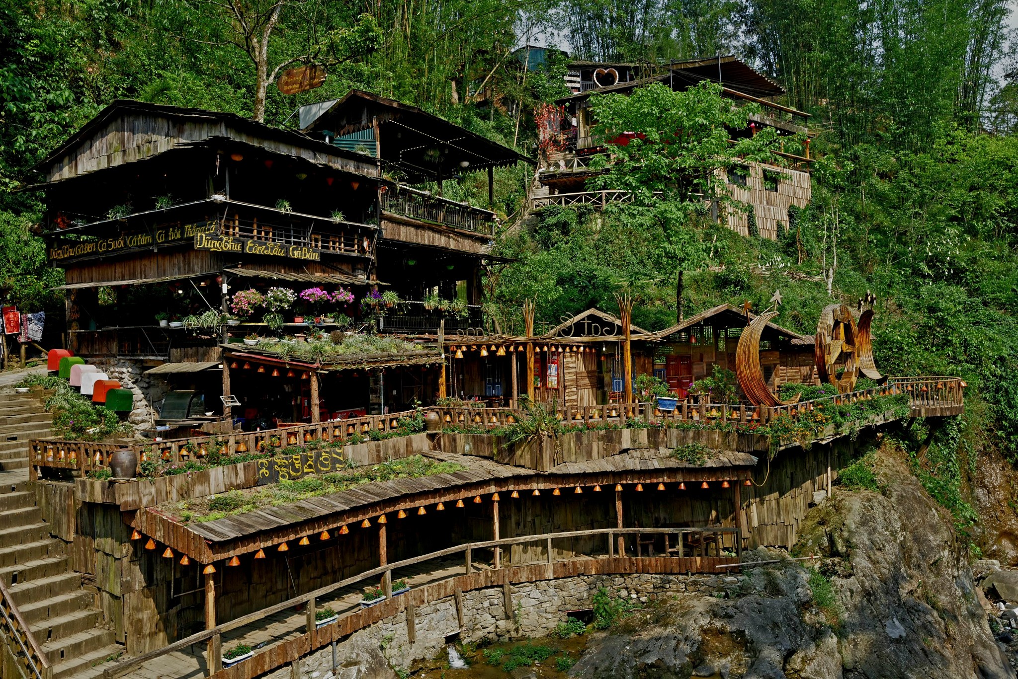 Scenic view of traditional stilt houses nestled in lush green Sapa mountains, perfect for cultural i.