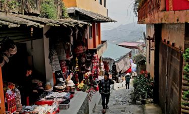 Charming Sapa village street with local shops and mountain views, perfect for cultural immersion and.