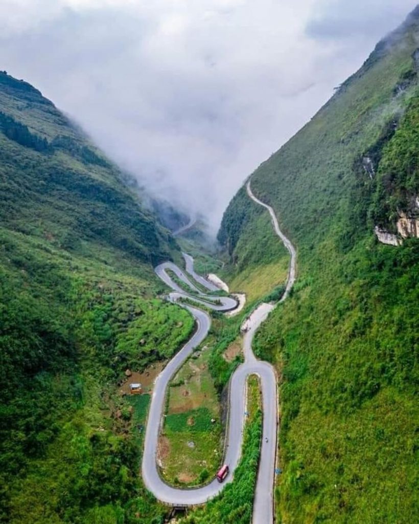 Stunning mountain pass in Sapa with winding roads and lush greenery, perfect for trekking and advent.