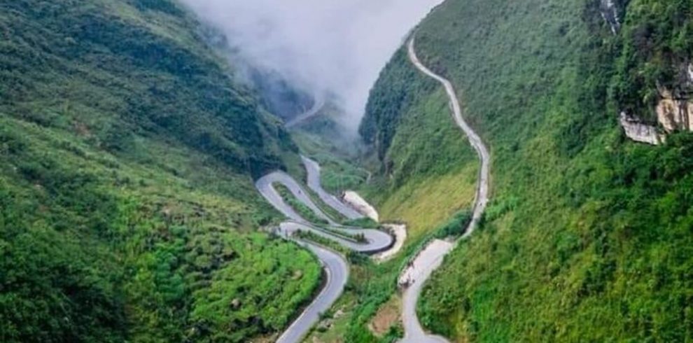 Stunning mountain pass in Sapa with winding roads and lush greenery, perfect for trekking and advent.