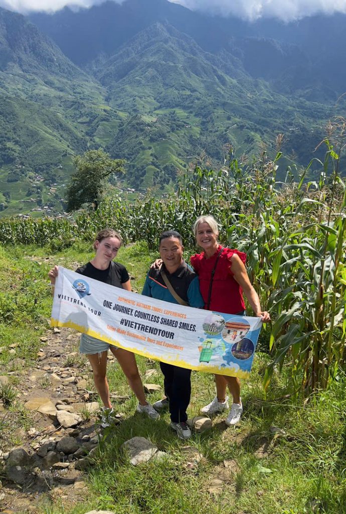 ViettrendTour hiking adventure in lush Sapa mountains with smiling travelers.