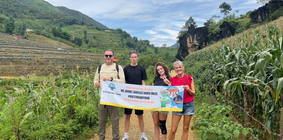 Hiking through lush green terraced fields in Sapa with scenic mountain views.