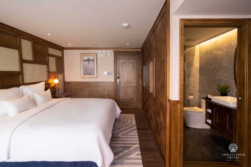 Scenic view of a luxurious cruise room with a private balcony overlooking Halong Bay, perfect for re.