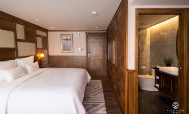 Scenic view of a luxurious cruise room with a private balcony overlooking Halong Bay, perfect for re.
