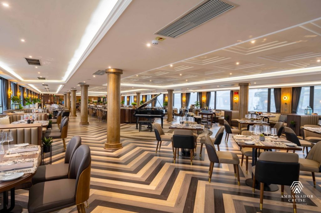 Luxurious cruise dining room with elegant decor and panoramic views of Halong Bay.