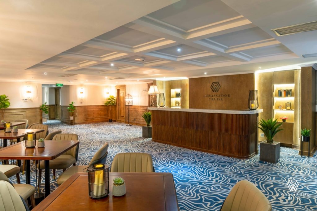 Relaxing lounge area on Halong Bay cruise with elegant decor and cozy seating.