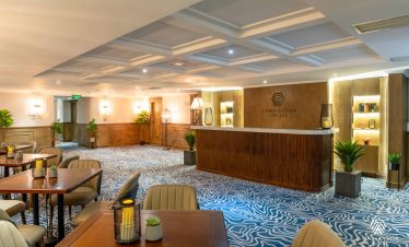 Relaxing lounge area on Halong Bay cruise with elegant decor and cozy seating.
