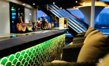 Relaxing cruise lounge with modern decor and scenic views of Halong Bay.