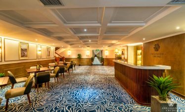 Luxurious cruise lounge with comfortable seating and ambient lighting, perfect for relaxing during H.