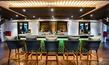 Halong Bay cruise bar with modern design and ambient lighting, perfect for relaxing and enjoying sce.