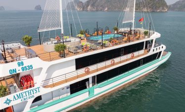 Stunning Halong Bay cruise ship with outdoor deck and swimming pool, scenic limestone islands, perfe.