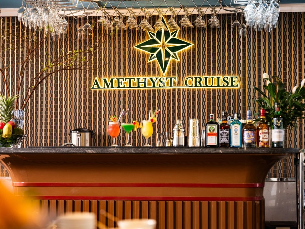 Elegant cruise bar with tropical cocktails and vibrant decor in Halong Bay.