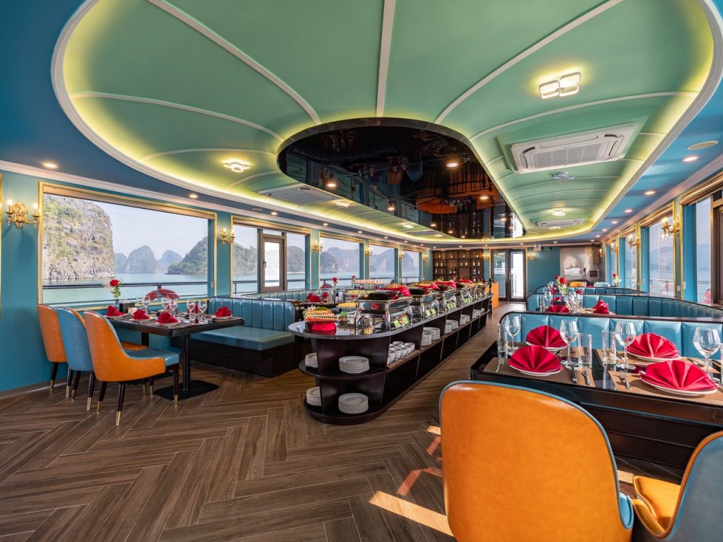 Luxurious cruise dining room with panoramic views of Halong Bay, elegant decor, and vibrant table se.