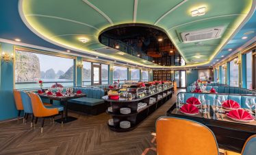 Luxurious cruise dining room with panoramic views of Halong Bay, elegant decor, and vibrant table se.