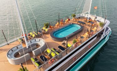 Stunning Halong Bay cruise balcony with panoramic views and luxurious amenities.