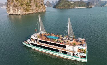 Stunning view of the Amethyst cruise sailing through Halong Bay's emerald waters with limestone kars.