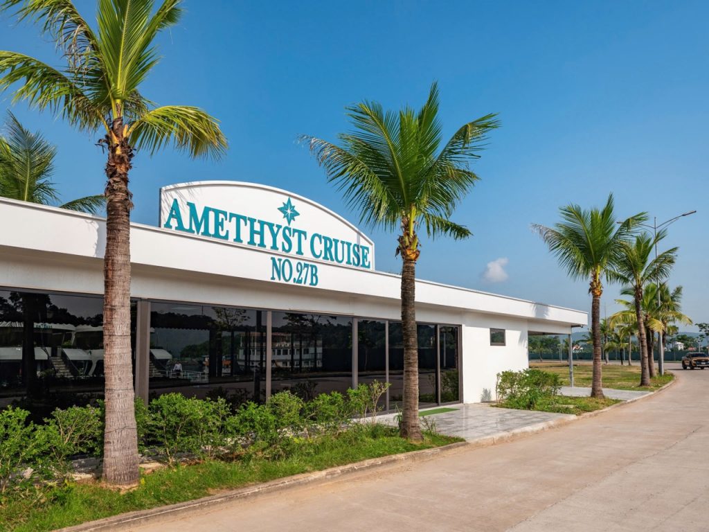Beautiful Halong Bay cruise terminal with palm trees and clear blue sky, inviting for a scenic day t.