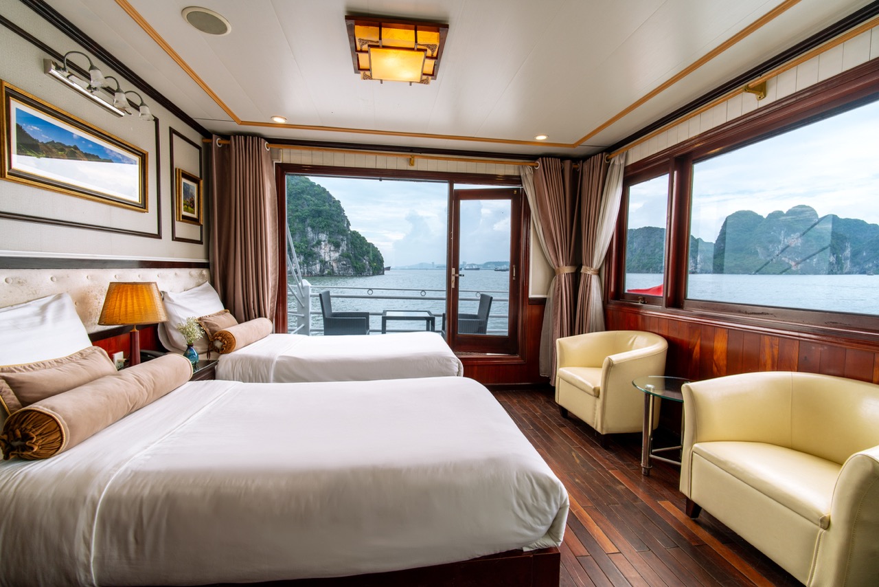 Stunning cruise balcony overlooking Halong Bay's emerald waters and limestone karsts, perfect for a.