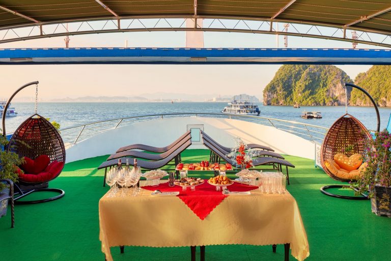 Stunning view of Ha Long Bay with luxurious cruise balcony and scenic limestone karsts.