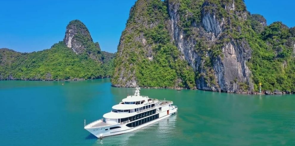 Beautiful scene of a luxury cruise sailing among limestone karsts in Halong Bay, Vietnam.