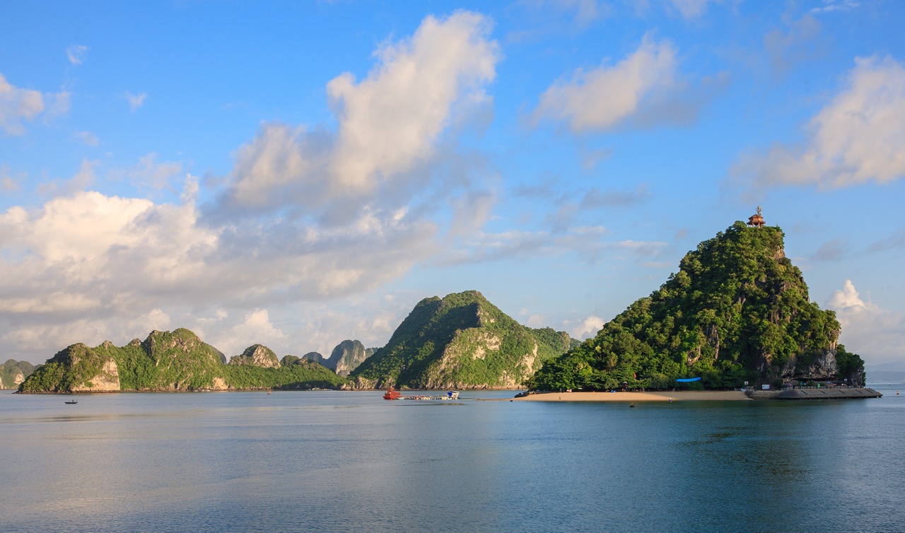 Stunning view of Halong Bay's limestone islands and calm waters from a luxury cruise balcony.