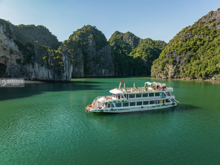Lan Ha Bay Day Cruise - Boat cruise in Halong Bay with lush green limestone islands - ViettrendTour.