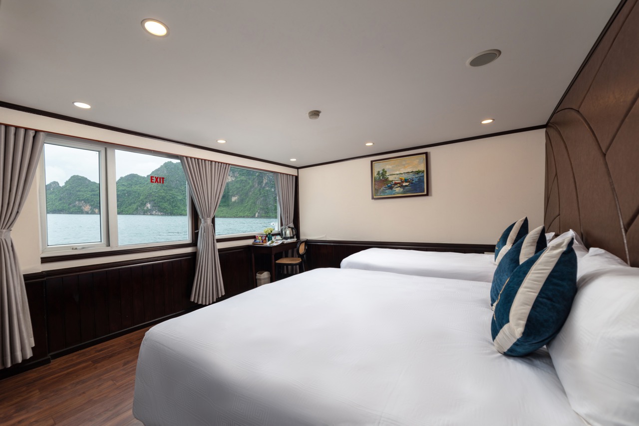 Spacious cruise cabin with river view, comfortable beds, and modern decor for a relaxing stay.