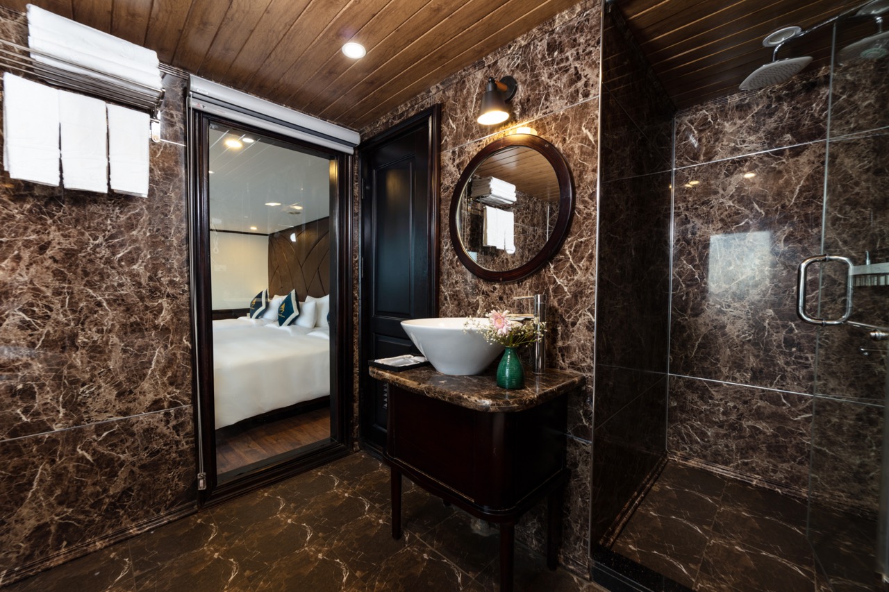 Luxurious marble bathroom with modern amenities at ViettrendTour resort.