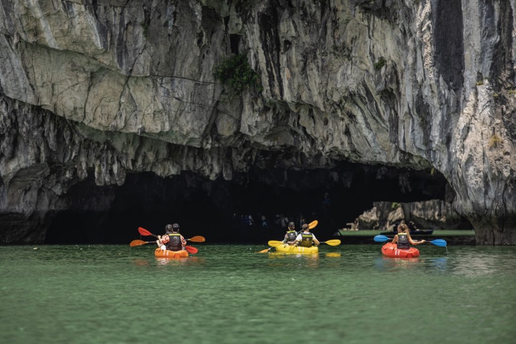 Kayaking in Halong Bay with stunning limestone cliffs and emerald waters, perfect for an adventurous.