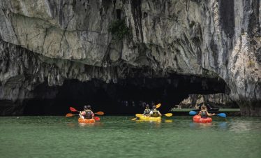 Kayaking in Halong Bay with stunning limestone cliffs and emerald waters, perfect for an adventurous.