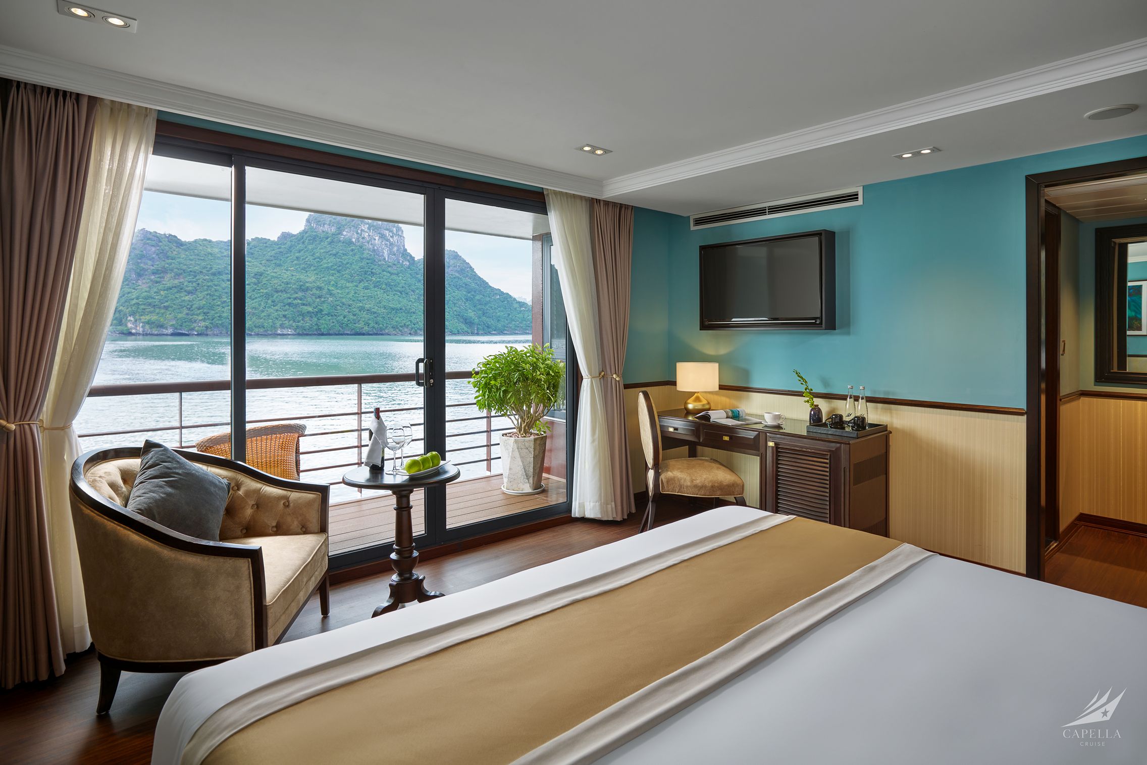 Luxurious cruise cabin with river view and balcony, modern amenities, and natural scenery.