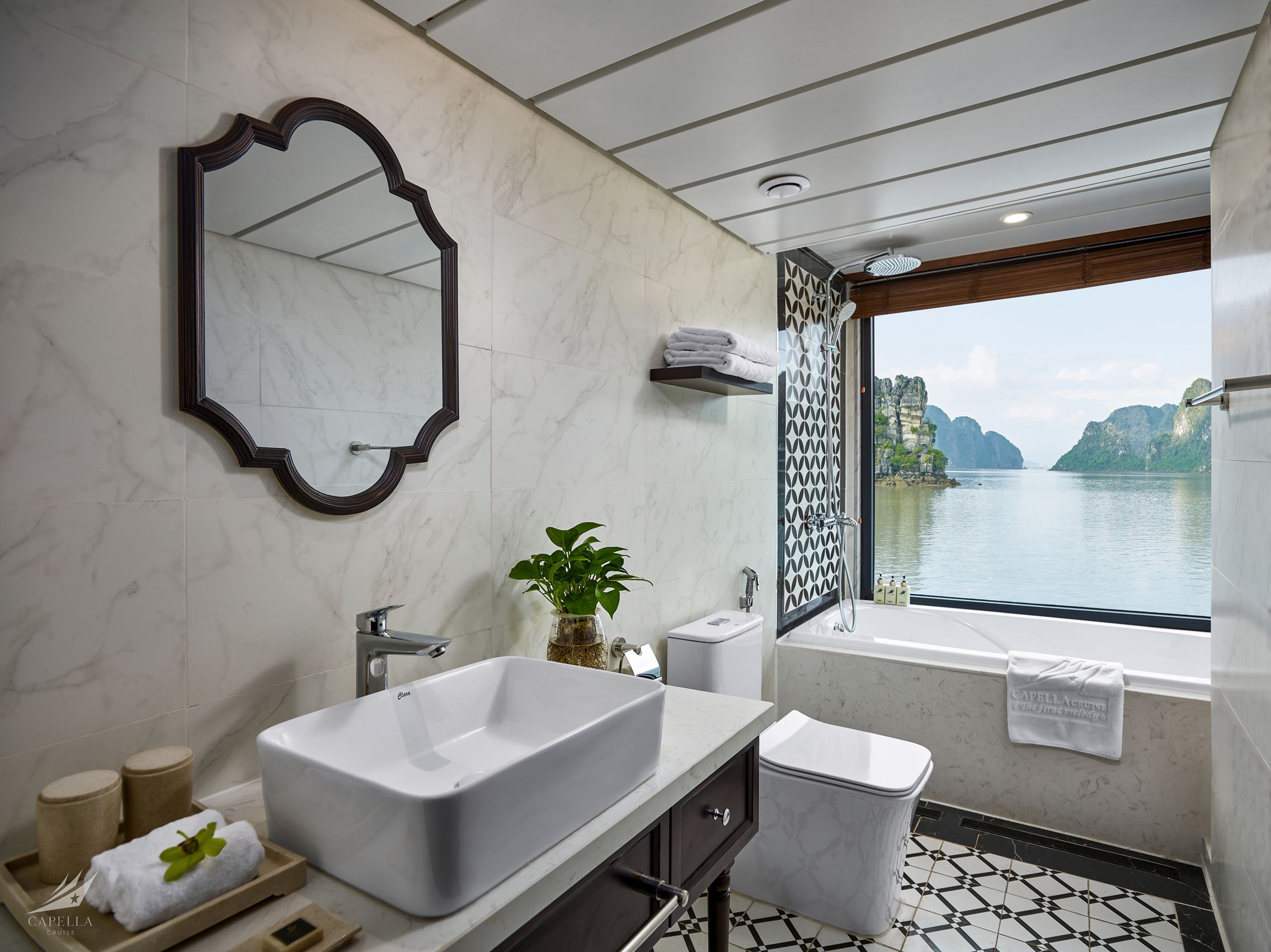 Stunning bathroom with scenic water view, modern fixtures, and elegant decor, perfect for luxury travel.