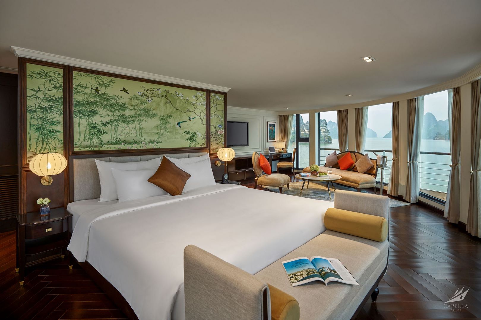 Luxurious hotel room with scenic bay view, modern decor, and comfortable seating area in Vietnam.