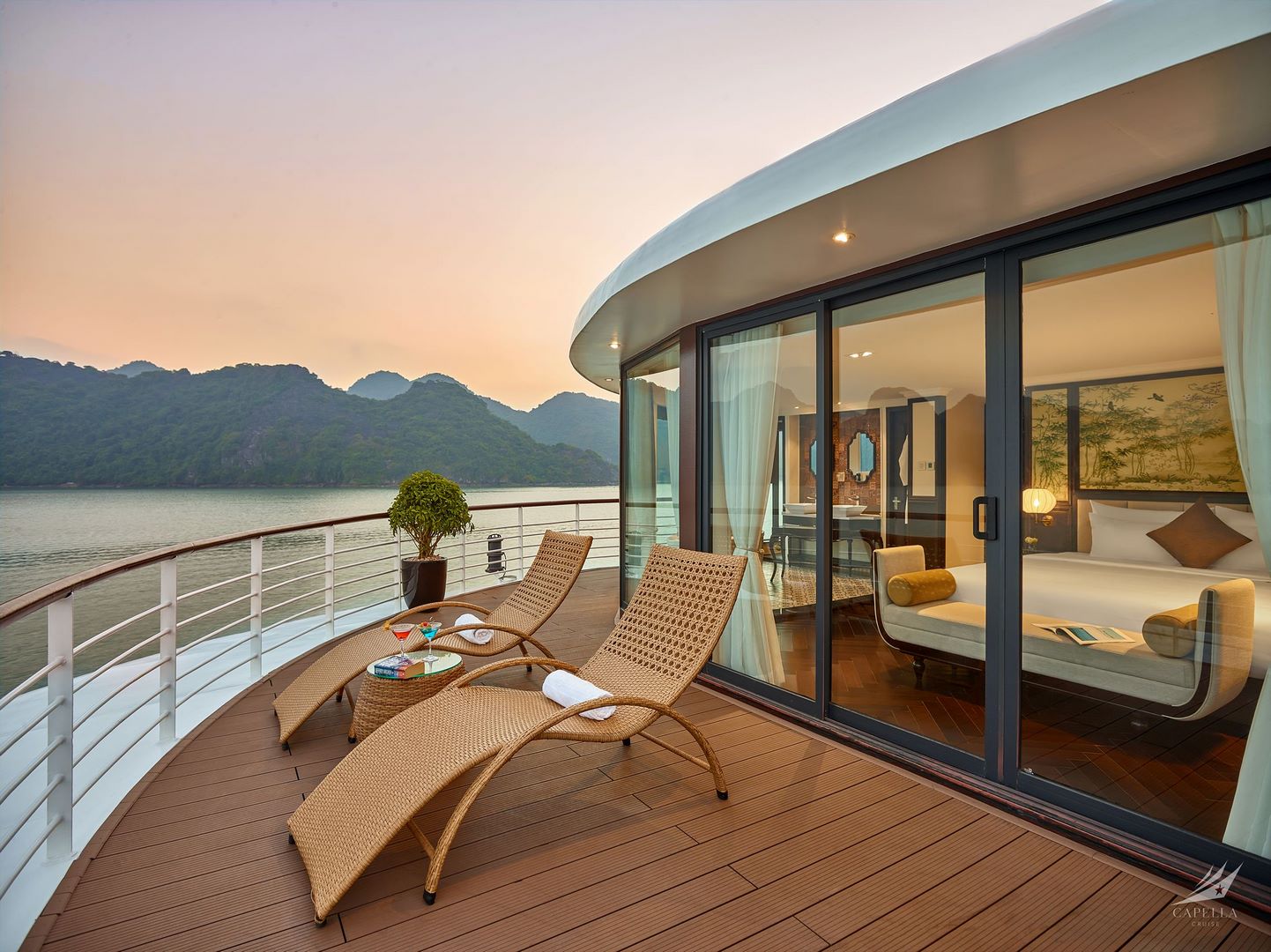 Luxurious lakefront hotel suite with private balcony and scenic mountain views.