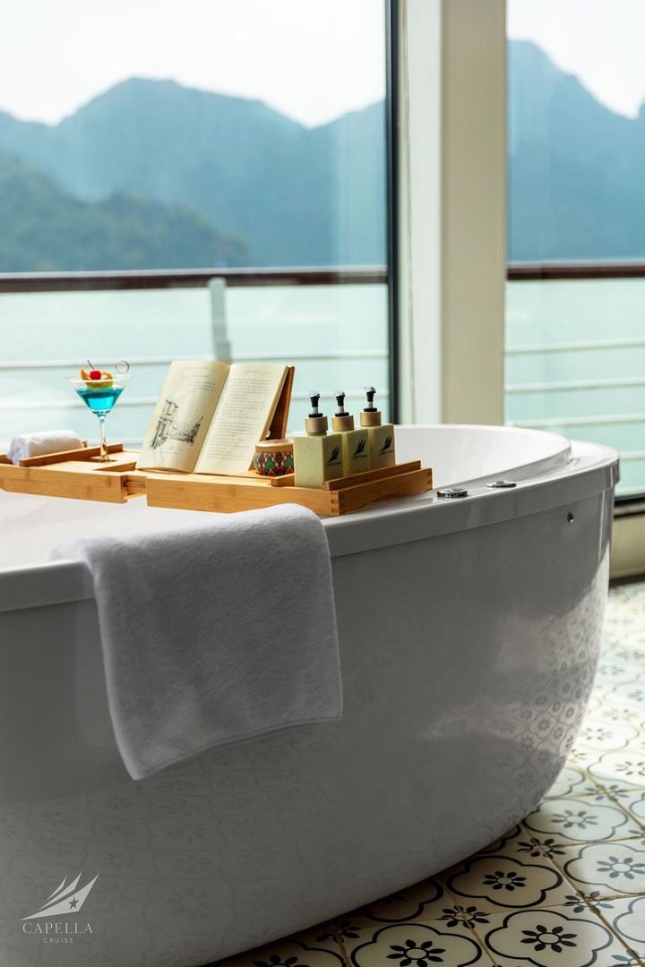 Relaxing bathtub with scenic mountain view, spa essentials, and luxury amenities in Vietnam.