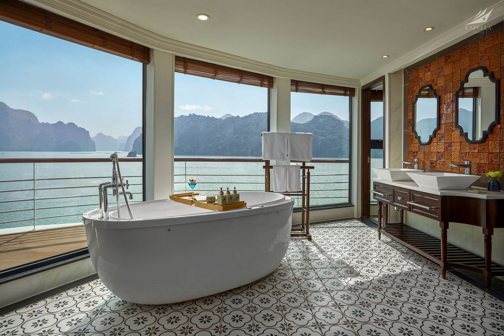Luxurious bathtub with scenic bay view in hillside resort room, perfect for relaxing vacations.