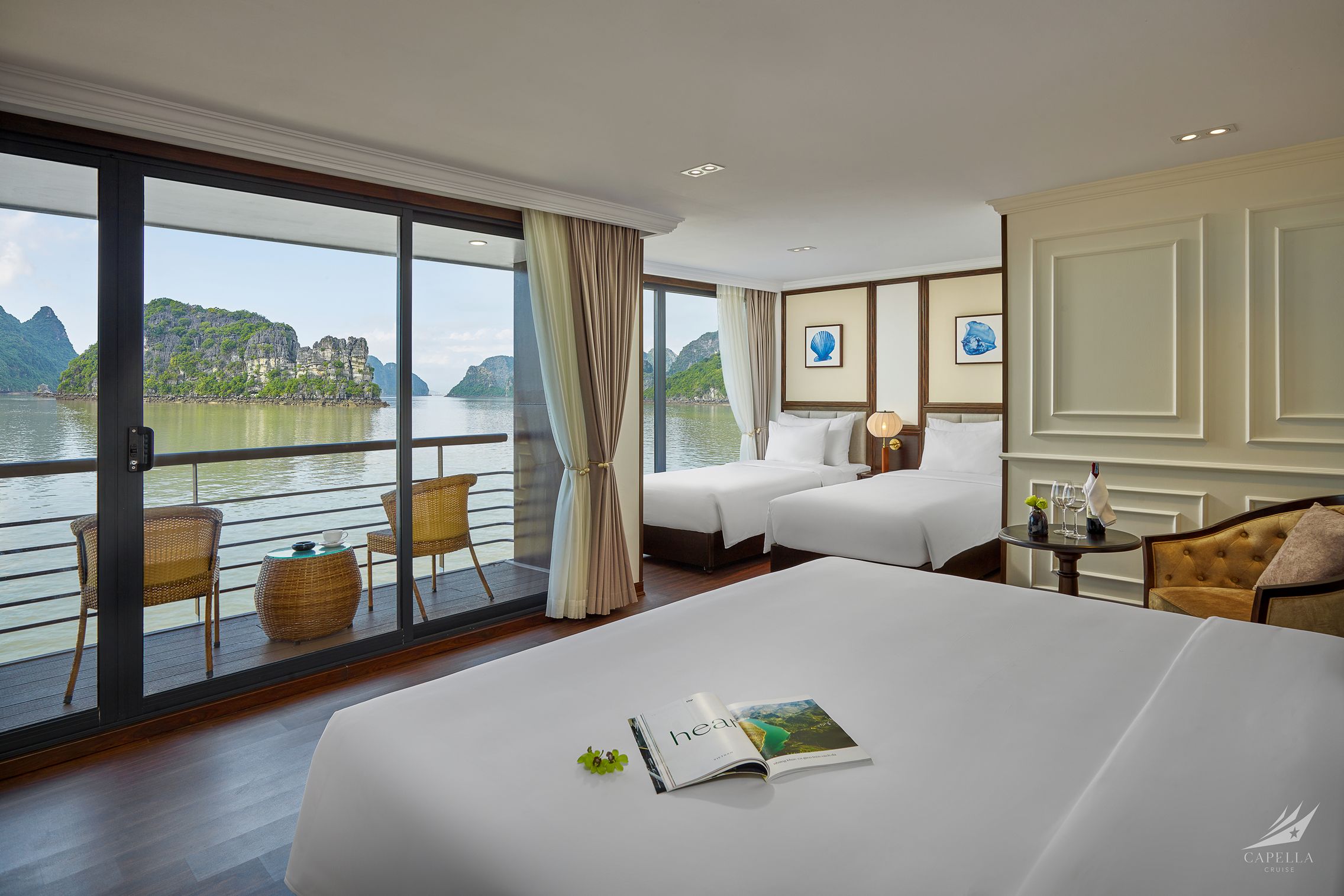 Stunning river-view hotel room with balcony, modern amenities, and scenic limestone islands in the background.