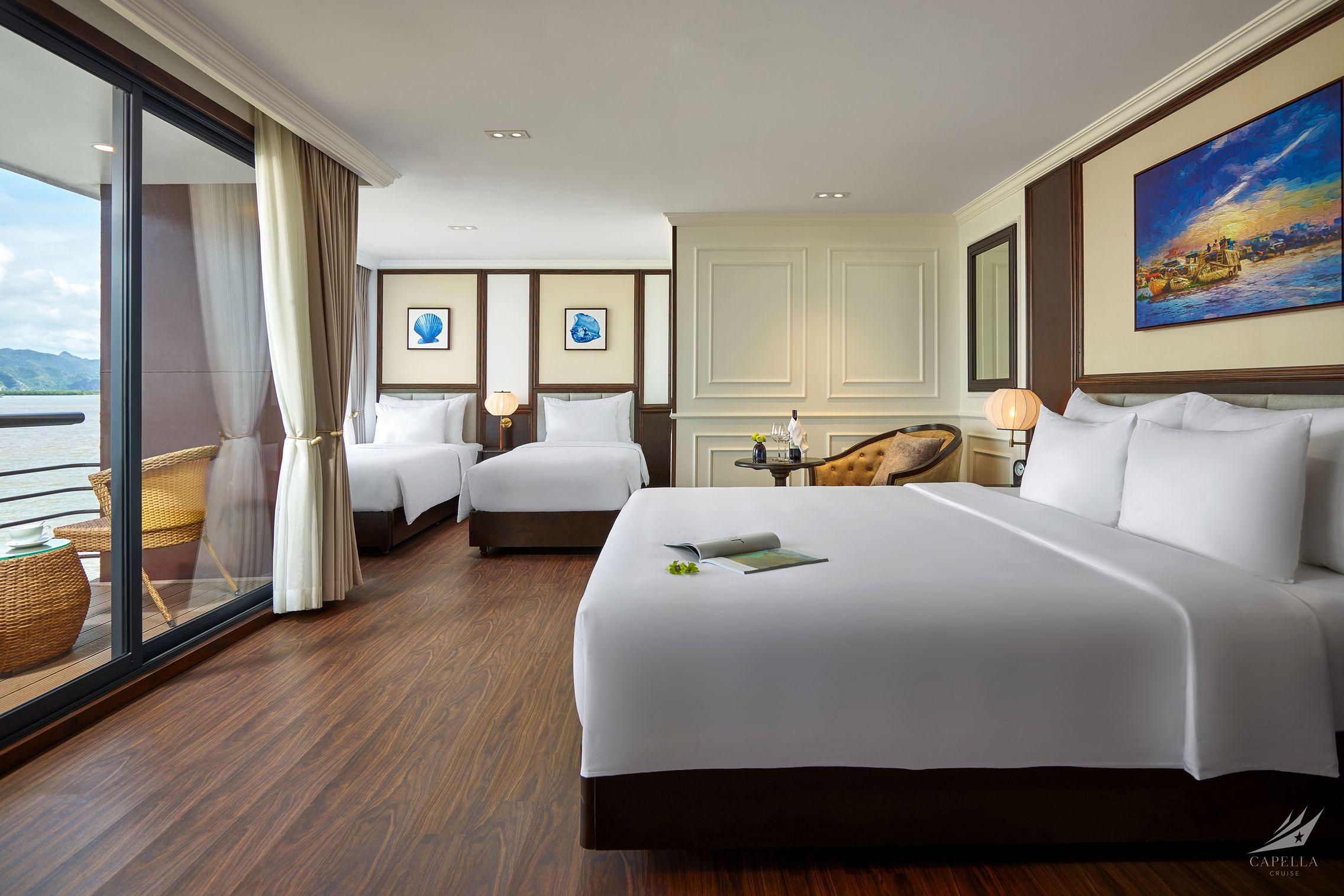 Luxurious hotel room with sea view, modern decor, and spacious beds, perfect for vacation stays.