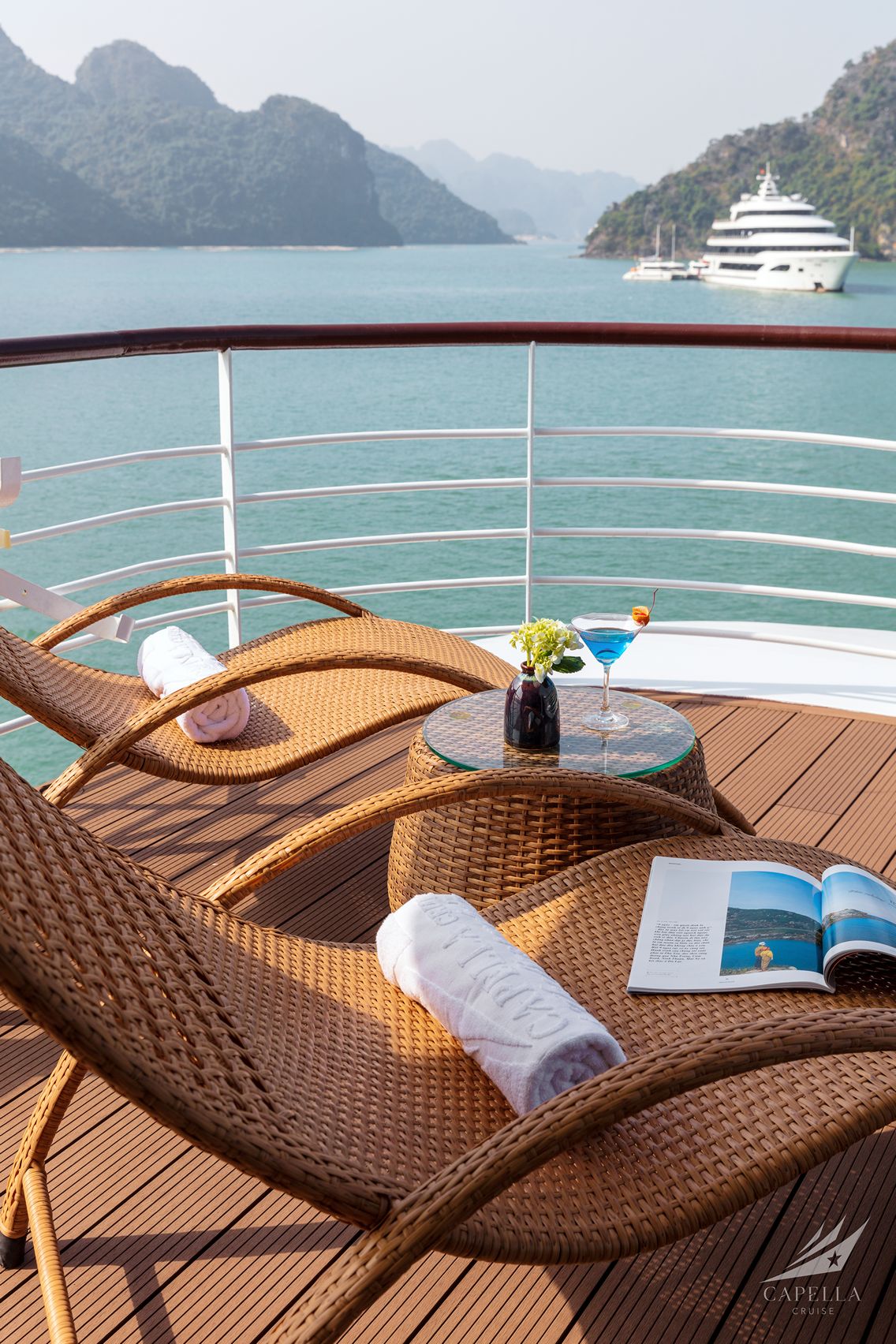 Relaxing on a luxury cruise deck with scenic island views and refreshing cocktails in Vietnam.