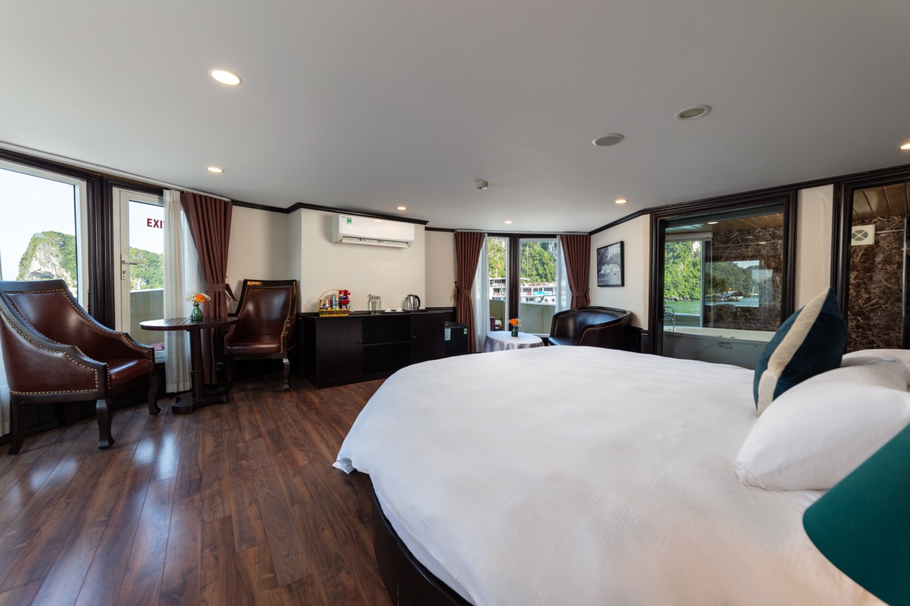 Elegant hotel room with balcony, modern decor, and scenic views for a luxurious stay.