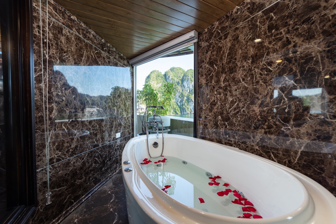 Luxurious bathtub with mountain view in a high-end Vietnamese hotel suite.