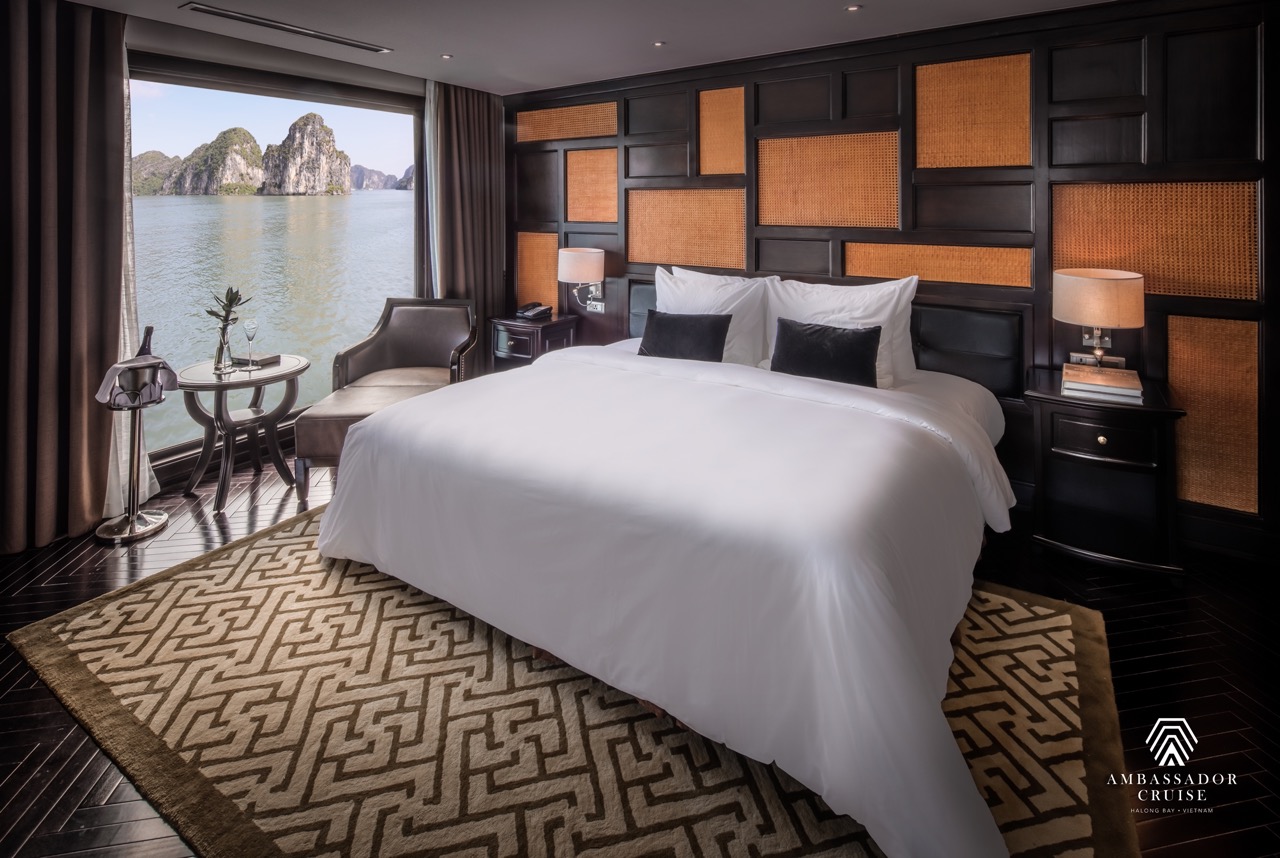 Stunning view of Halong Bay from a cruise balcony with elegant interior and serene waters.