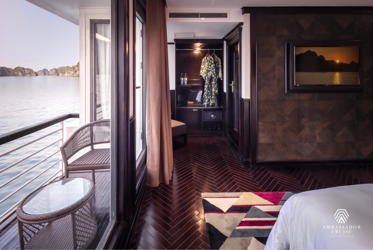 Stunning view from the cruise balcony showcasing Halong Bay's emerald waters and limestone karsts.