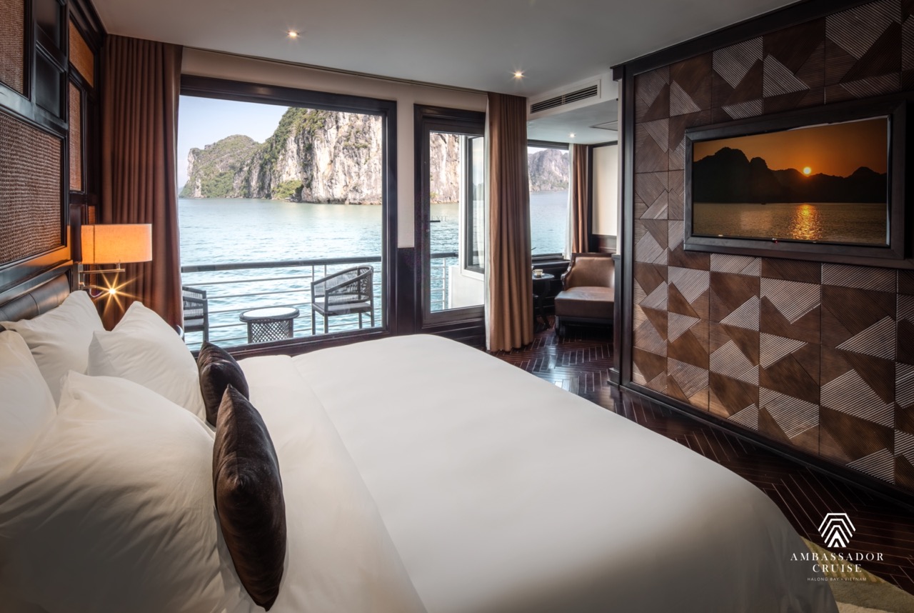 Stunning view of Halong Bay from a cruise balcony with modern interior and scenic limestone karsts.