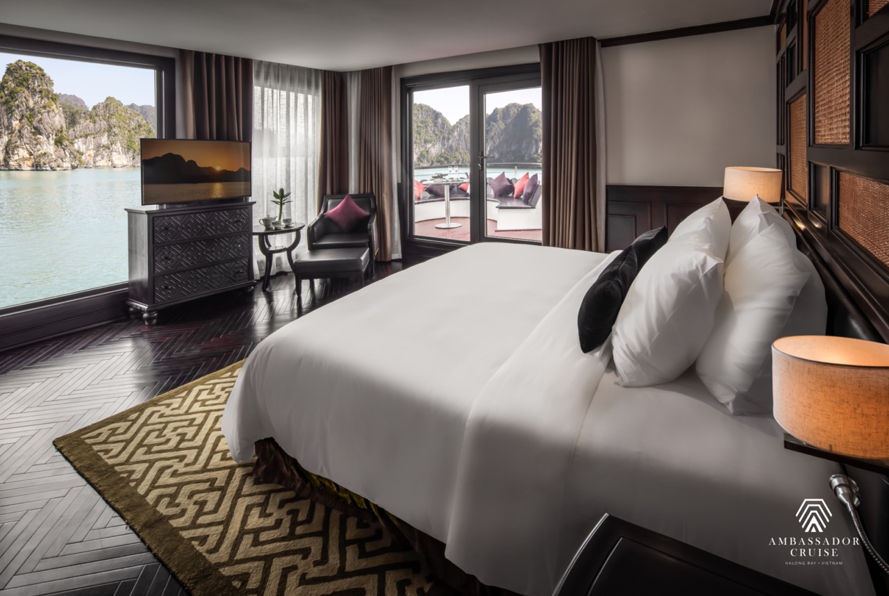 Luxurious cruise balcony room overlooking Halong Bay, perfect for a relaxing and scenic getaway.