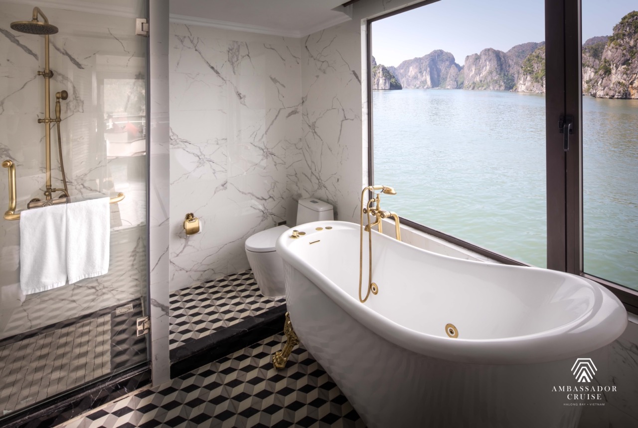 Elegant bathroom with panoramic Halong Bay view, luxurious bathtub, and modern decor for a premium t.