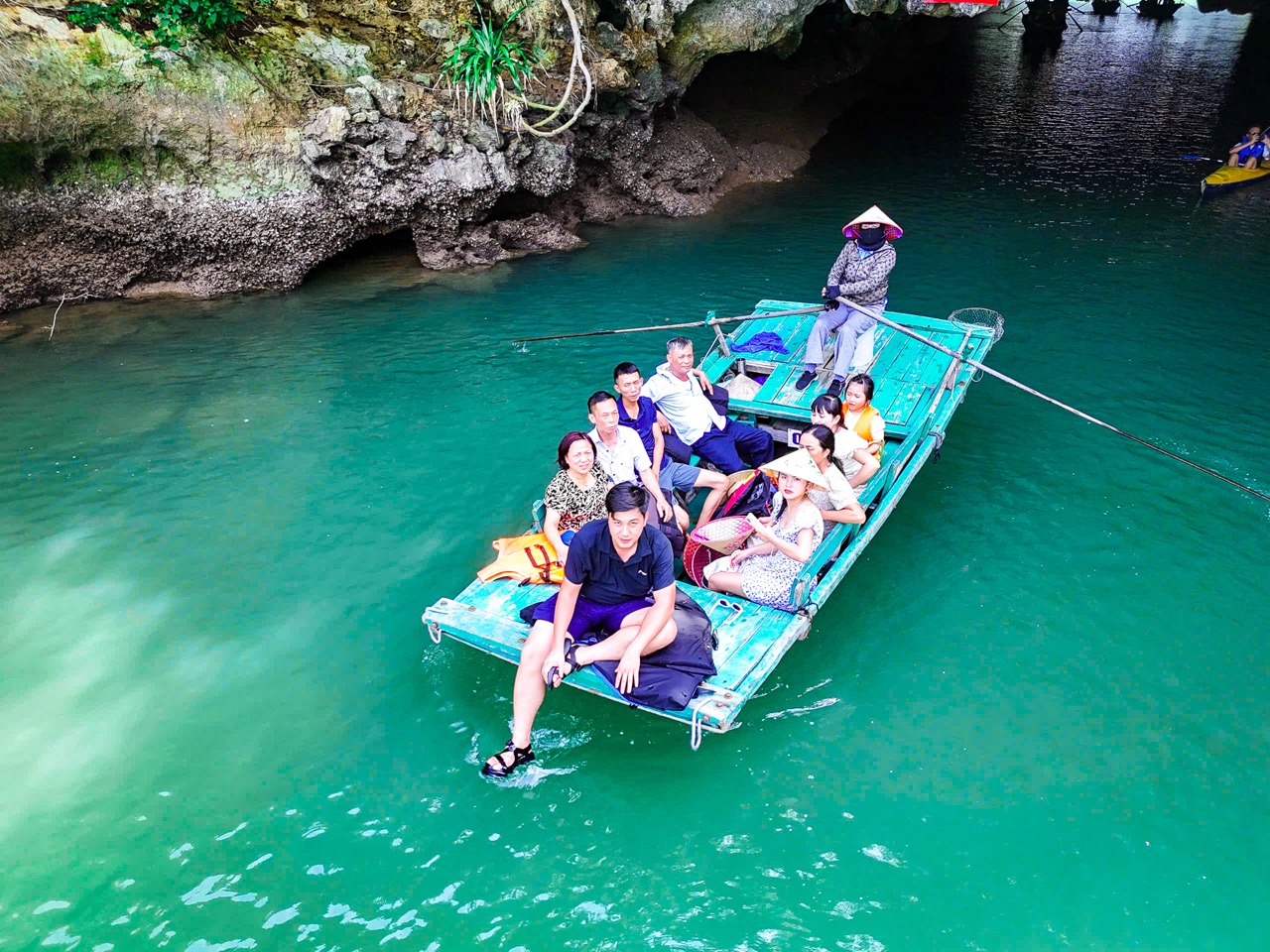 Lan Ha Bay kayaking adventure with tourists enjoying scenic views and turquoise waters.