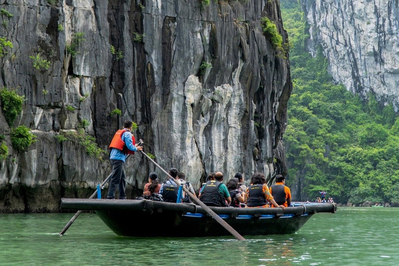 Amphibious boat tour exploring Ha Long Bay with limestone karsts and lush greenery in Vietnam.
