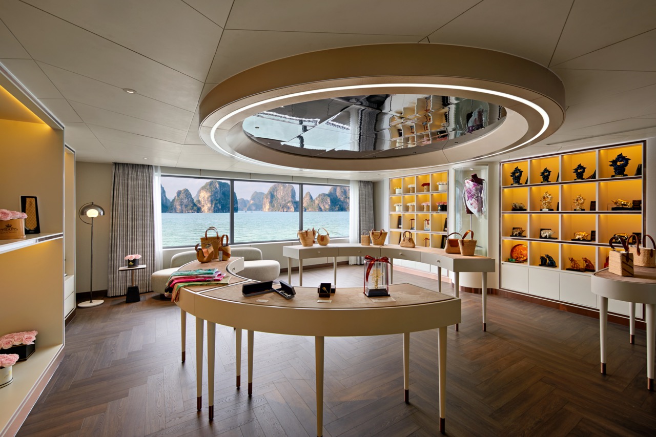 Elegant boutique shop with sea view, showcasing luxury handbags and accessories, bright interior, modern design, coastal scenery.